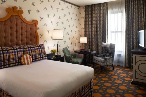 a hotel room with a bed and a tv at The Royal Sonesta Portland Downtown in Portland