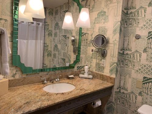 a bathroom with a sink and a mirror at The Royal Sonesta Portland Downtown in Portland