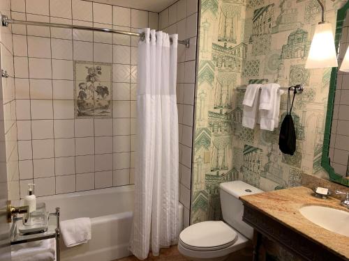 a bathroom with a toilet and a sink and a shower at The Royal Sonesta Portland Downtown in Portland