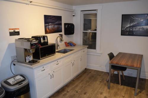 a kitchen with a sink and a table with a microwave at Hotel Ikon in San Francisco