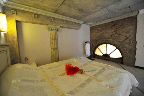 a bedroom with a bed in a room with a fireplace at Fontan in Chornomorsk