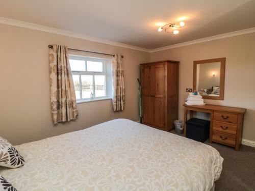 a bedroom with a bed and a window at Blakey in Liverton