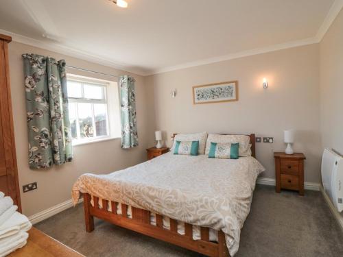 a bedroom with a bed and a window at Freeborough in Liverton