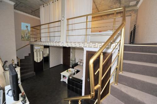 a room with a staircase with a loft at Fontan in Chornomorsk