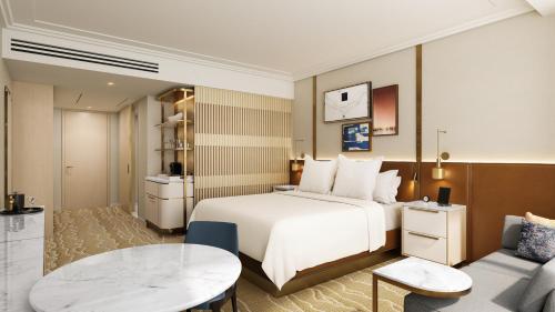 a hotel room with a bed and a table at Four Seasons Hotel Minneapolis in Minneapolis