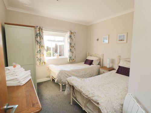 a bedroom with two beds and a window at Beacon in Saltburn-by-the-Sea