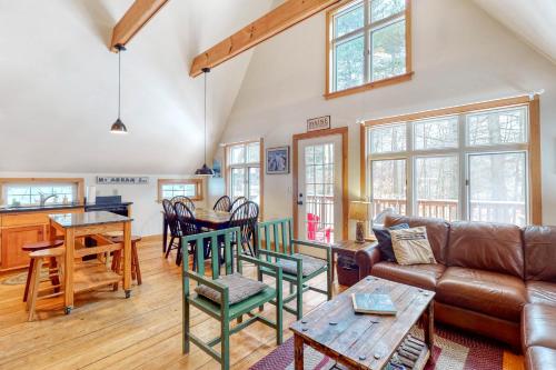 a living room with a couch and a table at Mullen Chalet in Greenwood