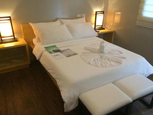 a bedroom with a white bed with two lights at Shore Time Hotel - Annex in Boracay