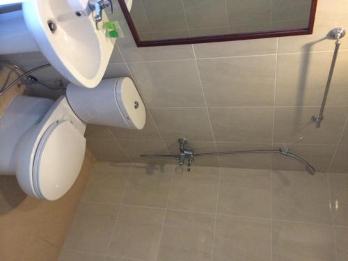 a bathroom with a toilet and a shower at Shore Time Hotel - Annex in Boracay