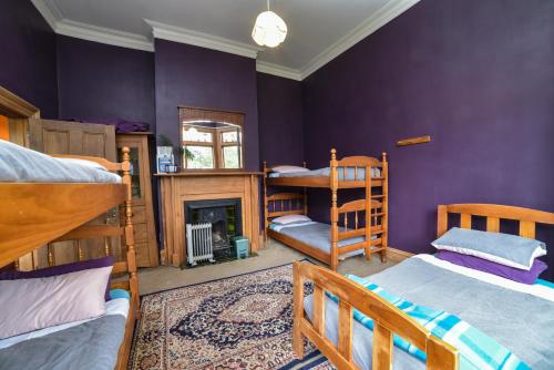 a bedroom with two bunk beds and a fireplace at Southern Comfort in Invercargill