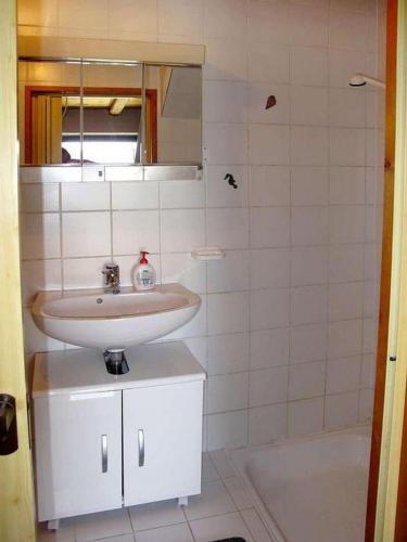 a bathroom with a sink and a bath tub at House Viskic in Supetarska Draga