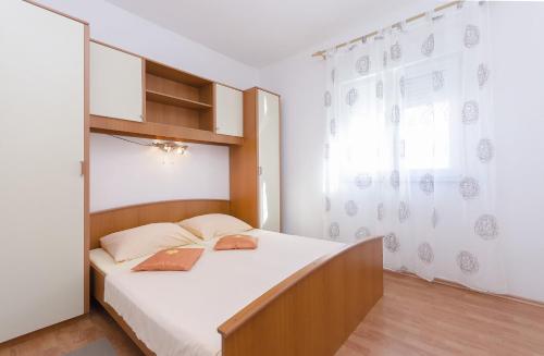 a bedroom with a bed and a window at Apartment Zdravko in Srima