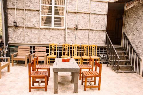 a table and chairs in front of a building at Ha Giang Creekside Lodging and Tours in Ha Giang