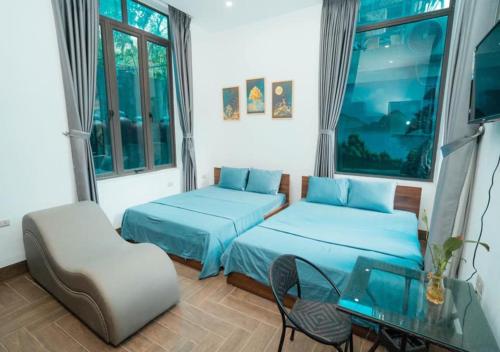 a room with two beds and a table and a chair at Story Villa Tam Đảo - Venuestay in Vĩnh Phúc
