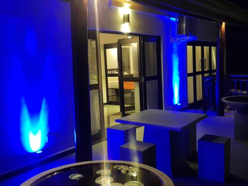 a blue room with a table and blue lights at Coconut Garden River Villa in Galle