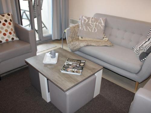 a living room with a couch and a coffee table at Nice apartment with terrace near the sea in Bray-Dunes