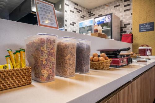 a counter with four containers of cereal and eggs at Hotel Rest Seogwipo in Seogwipo