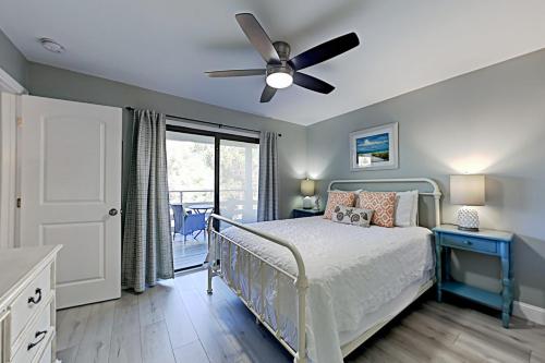 a bedroom with a bed and a ceiling fan at Fiddlers Cove III in Hilton Head Island