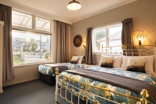 1 dormitorio con 2 camas y ventana en Oamaru Backpackers en Oamaru
