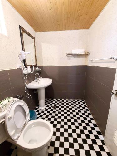 a bathroom with a black and white checkered floor at Rainbow SpringYU B&B in Nanzhuang