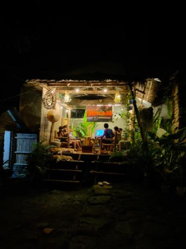 a group of people sitting at a restaurant at night at Payag n' Kapitan, Experience pinubre living in Siquijor