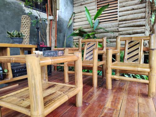 a wooden table and two chairs on a patio at Payag n' Kapitan, Experience pinubre living in Siquijor