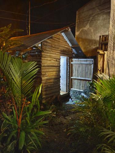 a small building with a window in a yard at Payag n' Kapitan, Experience pinubre living in Siquijor