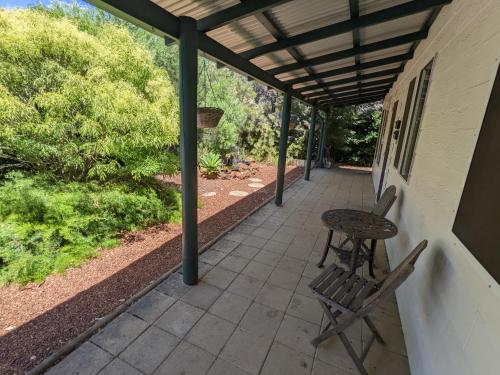 a patio area with chairs and a bench at The Cottage on George Street in Jarrahdale