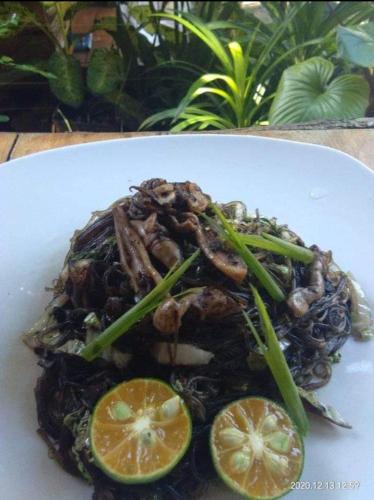 a plate of food on a white plate at Payag n' Kapitan, Experience pinubre living in Siquijor