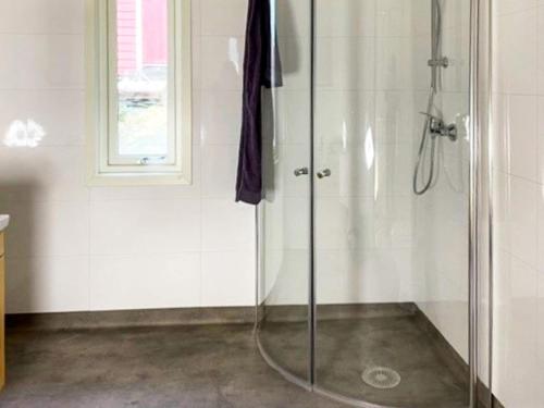 a shower with a glass door in a bathroom at Three-Bedroom Holiday home in Svelgen in Sørgulen