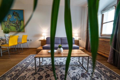 a living room with a couch and a table at Vila Vipolže - Rooms & J. Suites in Vipolže