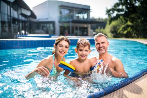 a family in a swimming pool with a frisbee at Residenz Royal in Gmünd