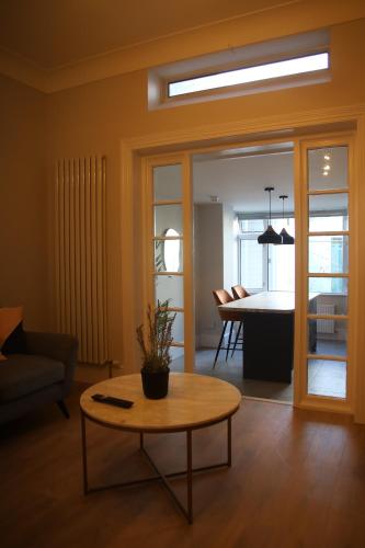 a living room with a table and a dining room at Crawford House- ScholarLee Living Apartments in Cork