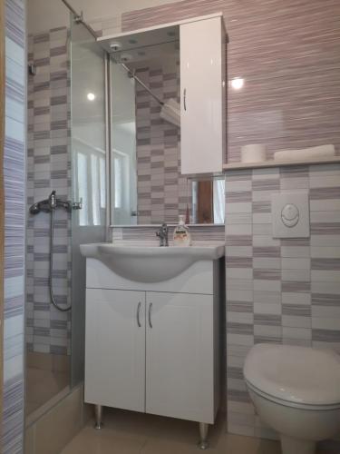 a bathroom with a sink and a toilet at Amanda C in Starigrad