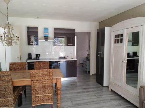 a kitchen with a wooden table and some chairs at Hof van Sellingen in Sellingen