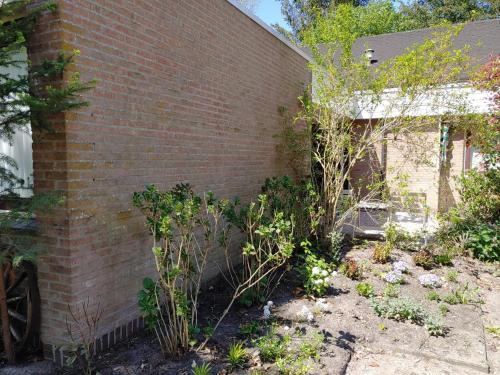 a brick building with a garden in front of it at Hof van Sellingen in Sellingen