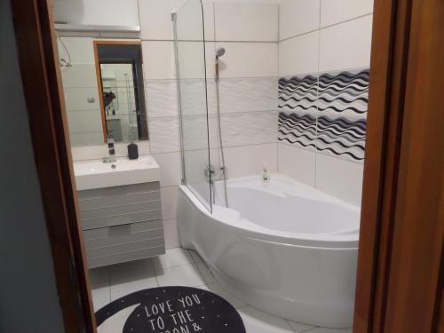 a bathroom with a tub and a toilet and a sink at DRS apartment, fully renovated flat in Budapest