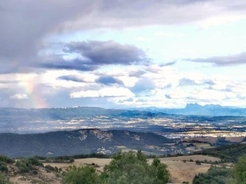 a view of a valley with a rainbow in the sky at Gîte Les Cadichons de la Grange in Saint-Péray