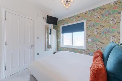 a bedroom with a white bed and a window at Florence House Boutique Hotel and Restaurant in Portsmouth