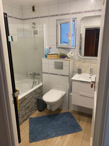 uma casa de banho com um WC, uma banheira e um lavatório. em GÎTE PRÈS DE LA FERME em Pfastatt