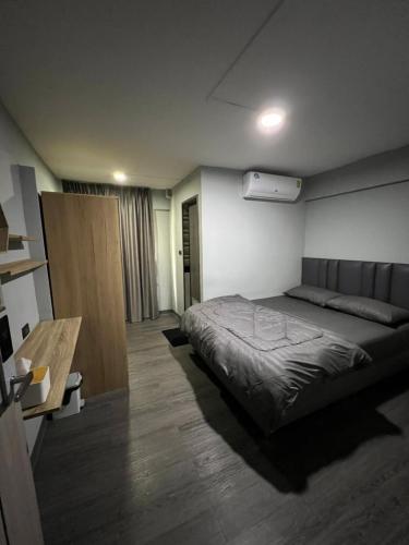a bedroom with a bed and a table in it at W71 in Bangkok