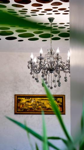 a chandelier hanging from a ceiling in a room at Motel Infinit in Târgu Jiu