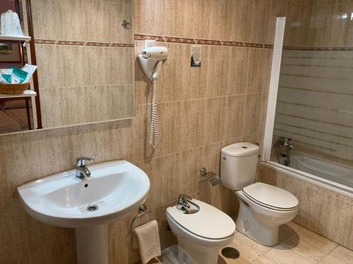 サセドンにあるHotel Rural Mariblancaのバスルーム(洗面台、トイレ付)、電話が備わります。