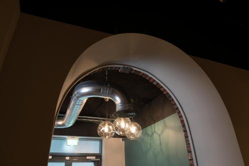 a light fixture hanging over a large mirror at The Heyford Hotel in Upper Heyford