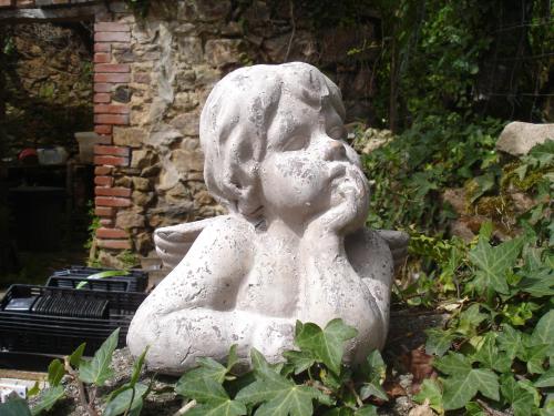 a statue of a girl sitting in a garden at Lazy Days in Rancon