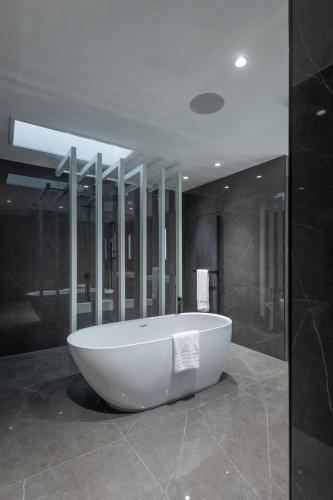 a large bathroom with a tub in the middle at The Heyford Hotel in Upper Heyford