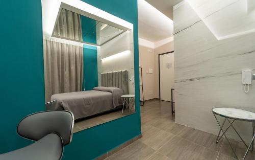 a room with a bed and a table and chairs at Intimity Luxury Rooms in Qualiano