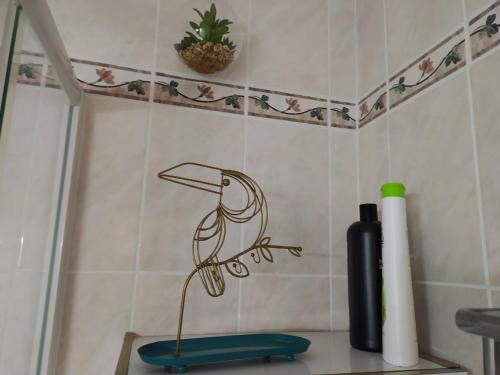 a bird on a branch stencil on a bathroom wall at Sun & Sea Apart in Bandol