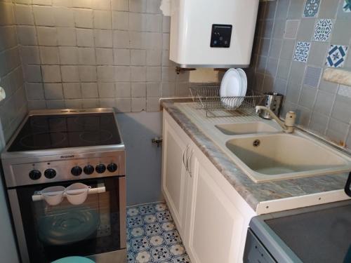 a small kitchen with a sink and a stove at Sun & Sea Apart in Bandol