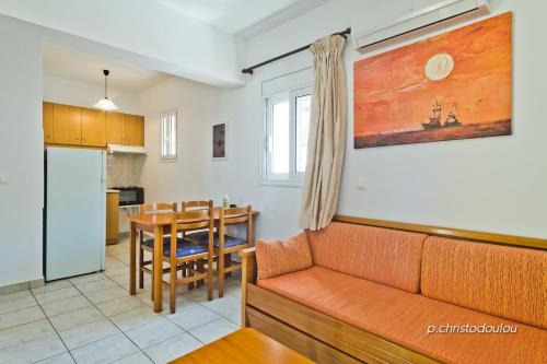 a living room with a couch and a table at Albatros Studios & Apartments in Lefkos Karpathou